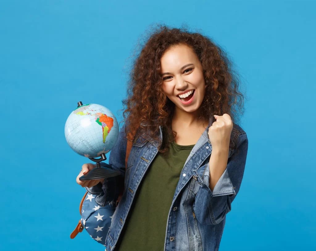 Estudante feliz segurando um globo